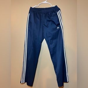Navy blue adidas sweatpants with white strips
